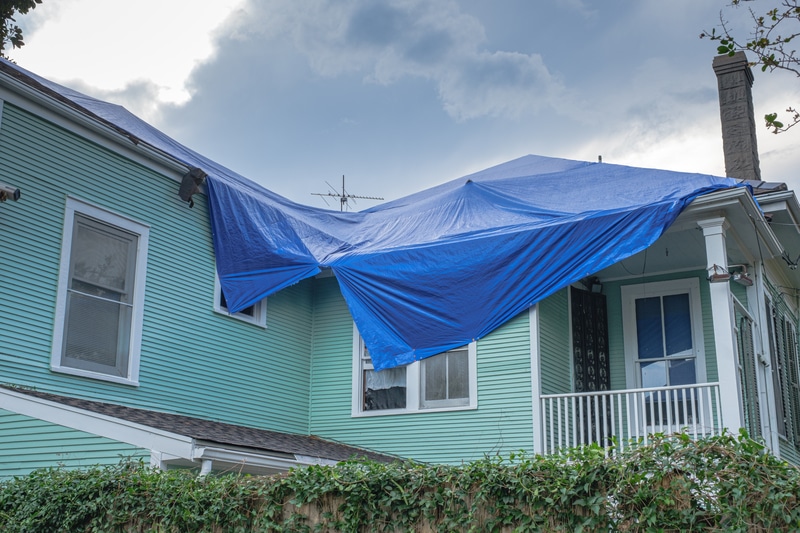 Roof covered in emergency siding tarp